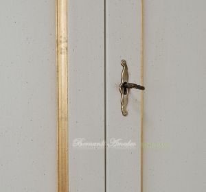 Classic wooden cabinet with white lacquered finish and hand-applied gold leaf